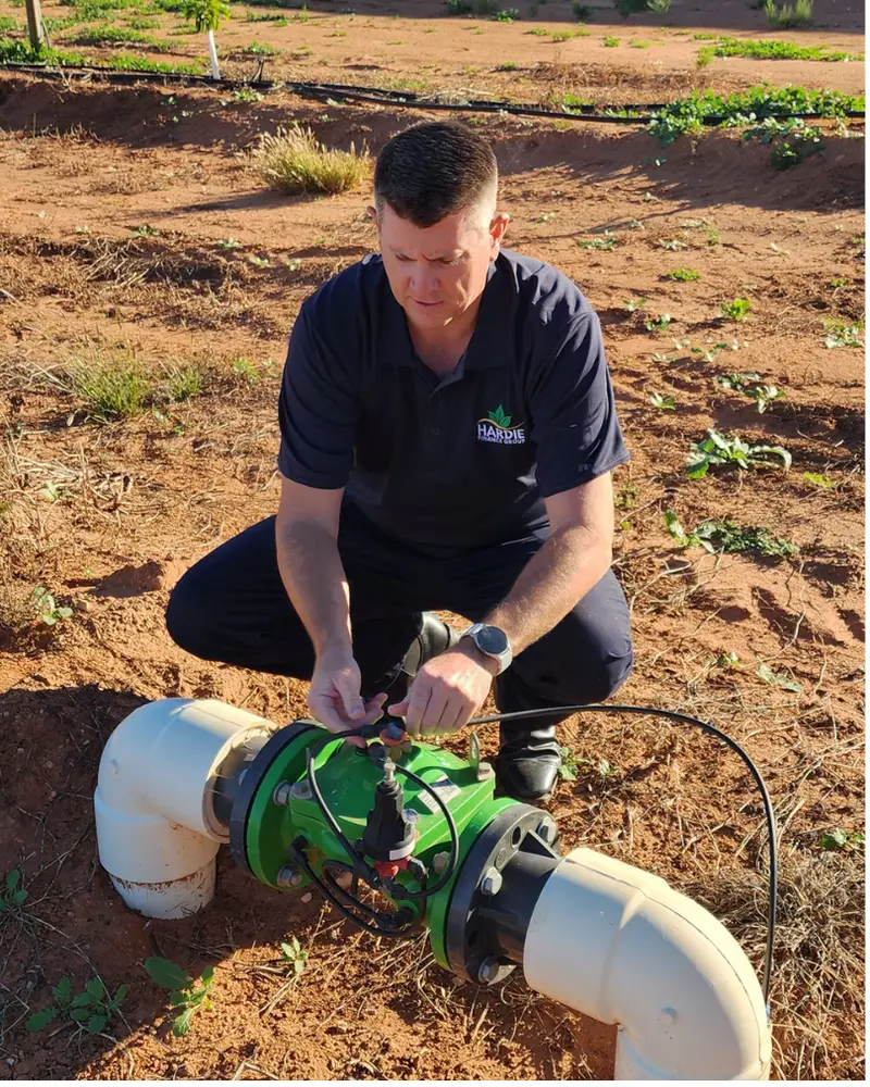 Adrian Hardie inspecting irrigation infrastructure