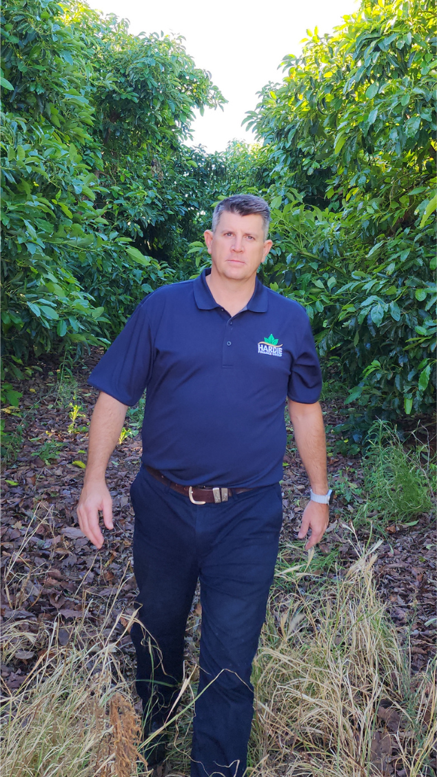 Horticulture Finance Broker Adrian Hardie walking through his avocado orchard in Sunraysia